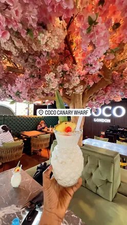 Outdoor dining at Coco Canary Wharf, featuring vibrant food and a celebratory atmosphere ideal for special occasions.