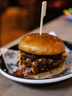 Family enjoying burgers, fries, and chicken tenders at The Beefy Boys in Cheltenham with their baby.