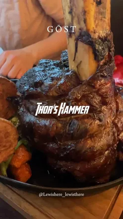 Two diners enjoy Thor's Hammer roast dinner at @gostglasgow, highlighting tender meat and delicious trimmings.