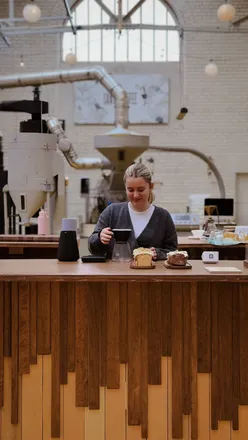 Interior of Santu Coffee in New Town, Edinburgh, featuring vintage decor and a vibrant coffee roastery atmosphere.