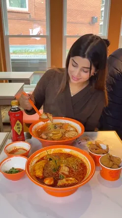 Colorful malatang bowls with spicy and tomato soup bases at Yanggoufu Malatang in London’s Chinatown.