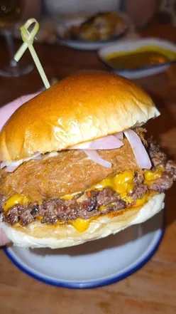 Delicious messy eats at Smokey Trotters: burgers, chicken tenders, loaded fries, and spring rolls in Glasgow.
