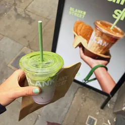 Iced blueberry matcha and pistachio cookie at Blank Street, London, a cozy spot for coffee lovers.