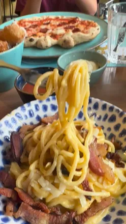 Mother and son enjoying pizza at Leopardos in Glasgow during a casual catch-up date.