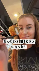 Bottomless sushi feast at a trendy Glasgow restaurant with vibrant decor and happy diners.