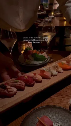 Diners enjoying sushi and Hanetsuki Gyozas at NIJŪ London in Mayfair, crafted by chef Kazutoshi Endo.