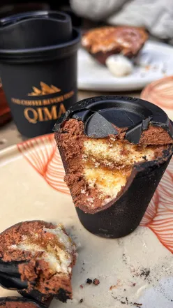 Imaginative desserts at Qima Cafe feature cacao bean shells and coffee mousse, showcasing stunning pastry artistry in London.