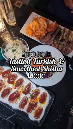 Delicious Turkish dishes and desserts at Amoura Lounge in Leicester, featuring Shisha and vibrant decor.