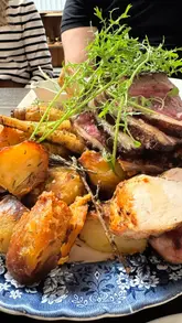 Guests enjoying farm-fresh meals at Castle Farm in Midford, showcasing rustic dining and vibrant, local dishes.