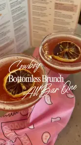 Friends enjoying Cowboy Bottomless Brunch at All Bar One, Liverpool, with drinks and brunch dishes in cowboy hats.