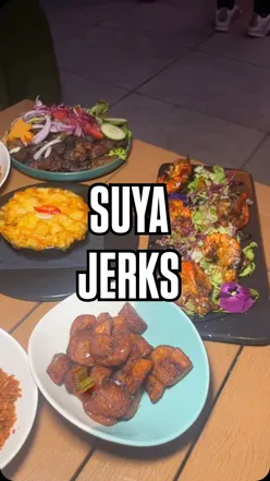 Delicious Jamaican jerk chicken meal at Suyajerks in Stratford, showcasing vibrant flavors at Cococure Haus.