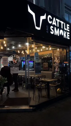 Delicious Munch Box with BBQ wings, Nashville burger, and cheesy chips at Cattle & Smoke in Leicester.