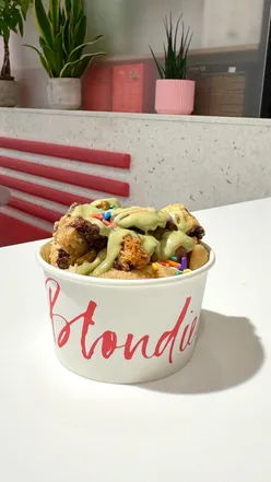 Indulging in Kinder Bueno cookie dough at Blondies Kitchen's new bar in Selfridges, London, topped with rich sauces.