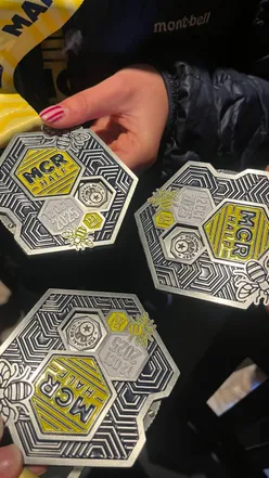 Runner celebrating a personal best at the Manchester Half Marathon with excitement and determination