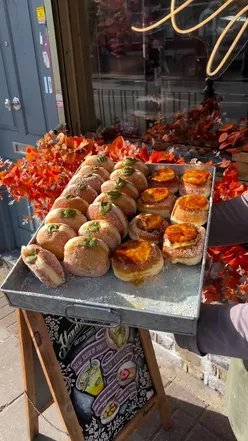 Indulging in aesthetic sweets at Greedy Cow Bakes, Bethnal Green, with vibrant desserts and unique drinks.