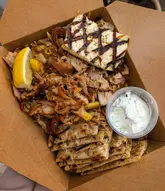 Delicious Greek meals in Edinburgh, featuring mixed gyro, chicken gyro, and prawn skewers served with fresh sides.