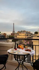 Balcony views from the Eiffel Parisian Suite at Four Seasons George V, showcasing a stunning Parisian skyline.