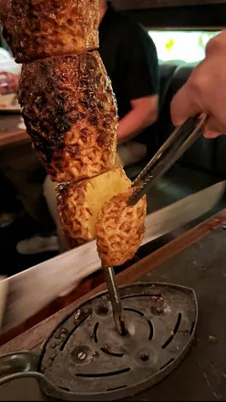 Meat lovers at Fazenda enjoy a Churrasco feast of picanha, lobster tail, and roasted pineapple in Manchester, UK.