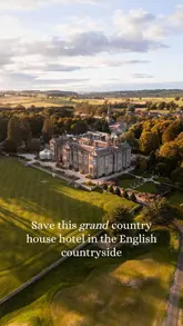 Exterior view of the luxurious Matfen Hall hotel in Northumberland's countryside, showcasing its grand architecture and gardens.