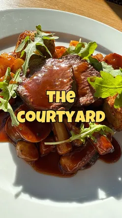 Diners enjoying seasonal dishes at The Courtyard in Pegswood, embracing farm-to-table and gluten-free options.