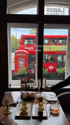 Afternoon tea featuring floral delights and pastries at London Marriott Hotel Park Lane's magical garden setting.