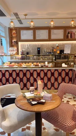 Colorful macarons and Ispahan latte at Pierre Hermé's Covent Garden boutique, perfect for tea lovers!