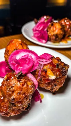 Delicious chicken burger and sweetcorn fritters at Turtle Bay, showcasing flavorful Caribbean cuisine in London.