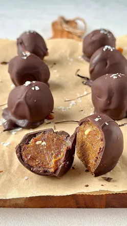 Homemade soy date caramel chocolates topped with sea salt, showcasing a delicious, sweet, and salty treat.