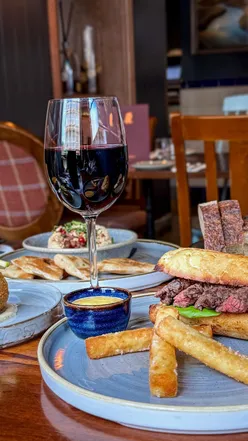 Diner enjoying a cozy meal of small plates at The Loveable Rogue in Glasgow's West End, featuring gourmet dishes.