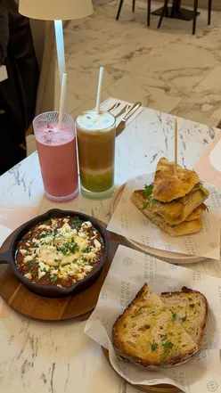 Guests enjoying a trio of dessert bites and iced lattes at Heavenly Desserts in Cheetham Hill, Manchester.