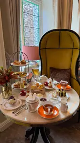 Indulgent afternoon tea inspired by Marie Antoinette at Belmond Cadogan in London, featuring exquisite treats and scents.