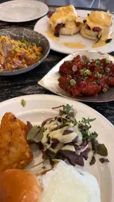 Indulging in a bottomless brunch at Zouk Tea Bar in Manchester, featuring Bollywood Benedict and vibrant cocktails.