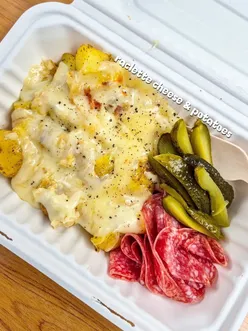 CheeseBox Glasgow serving raclette, zapiekanka, and more at a vibrant food spot, showcasing delicious cheesy dishes.