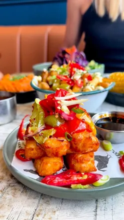 “Rotisserie chicken cooking at Spit Roast Kitchen, showcasing teamwork and passion behind every delicious dish.”