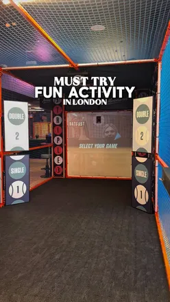 Group enjoying a 20” double pepperoni pizza and drinks at Moonshot Social, an immersive sports venue in London.