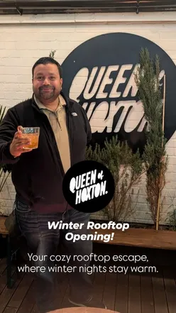 Cozy winter rooftop at Queen of Hoxton, featuring firepits, fairy lights, and a festive yurt in Shoreditch, London.