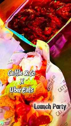 Guests enjoying a lively launch party at Cattle & Co in Swansea, featuring wings, nachos, cocktails, and bingo fun.