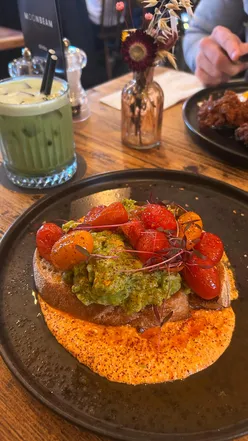 Cozy coffee spot in Manchester with vibrant decor, perfect for brunch, featuring avocado toast and specialty coffee.