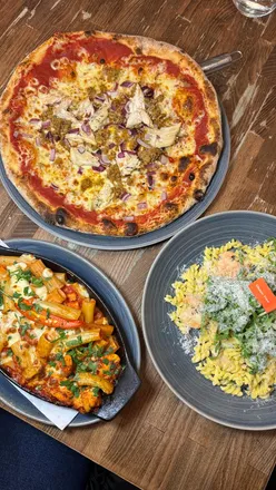 diners enjoying gluten-free Italian cuisine at Prezzo in Leeds, featuring pizzas and pasta dishes.