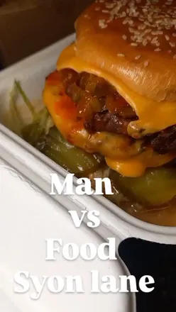 Delicious burger and ribs from Man vs Food London, satisfying cravings with fresh, tasty takeaway. Perfect treat!