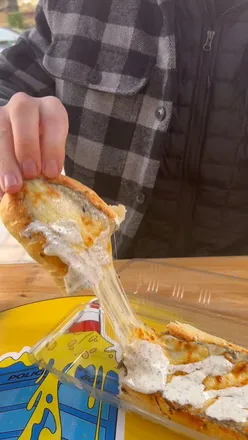 Delicious raclette cheese and zapiekanka served at Cheese Box Glasgow, an old police box turned foodie gem.