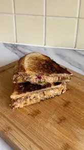 Delicious spicy cheese and tuna toastie with jalapeños on sourdough, perfect for an ASMR food experience.