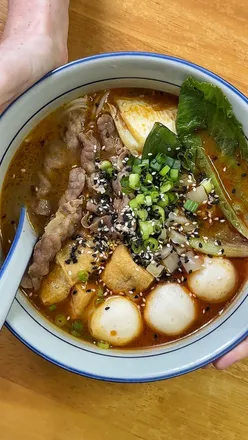 HK-style hot and sour noodle soup at a hidden gem in Stockport, featuring spicy pig ear salad and cumin wings.