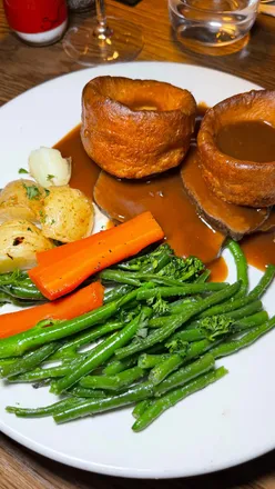Delicious Sunday roast with beef, gravy, and a variety of sides at The Riverside 1901 in Glasgow.