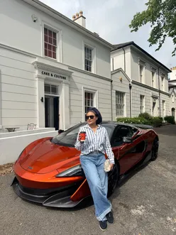Al enjoying coffee to go at Cake and Culture in Edgbaston Village, Birmingham, with a McLaren parked nearby.