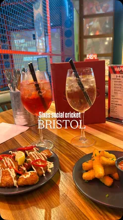 Fran and Steph enjoying drinks and cricket at Sixes Social in Bristol, laughing and having a fun day out.