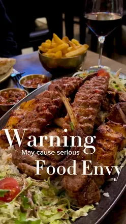 A delicious Turkish feast at Lezzet Newcastle featuring mixed grill, dumplings, and patlican ezme with homemade bread.