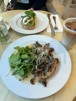 Brunch at The Trough in Daylesford Organic, Cotswolds, featuring mushrooms on toast and avocado eggs.