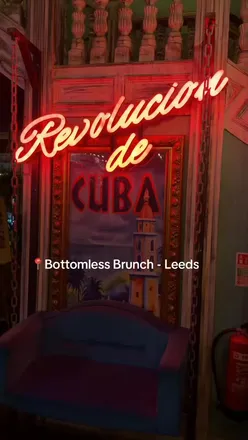 Team enjoying bottomless brunch at Rev De Cuba in Leeds with drinks and vibrant atmosphere.