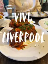 Group enjoying a delicious Italian meal at @vivi_liverpool, celebrating dress shopping with tasty dishes and lemony cocktails.